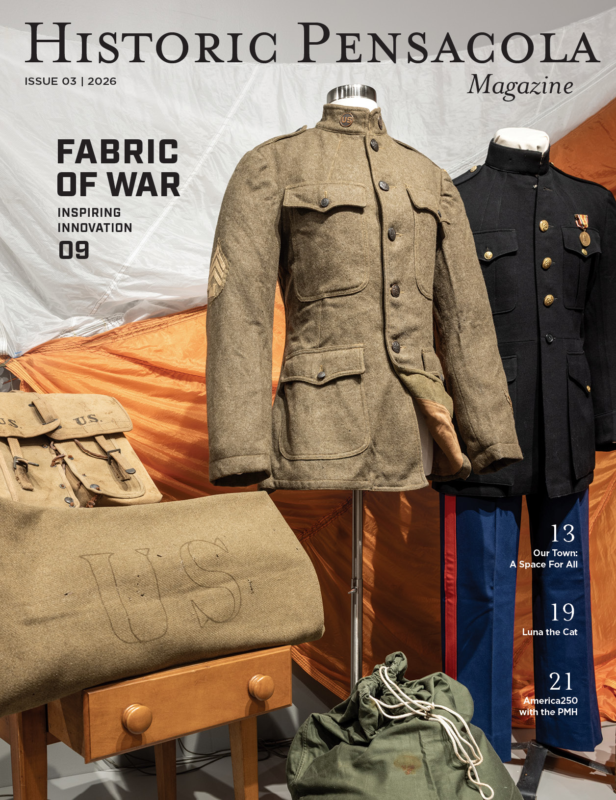 The cover of the 2026 issue of Historic Pensacola Magazine featuring historic US military uniforms from a Museum of History exhibit titled Fabric of War.