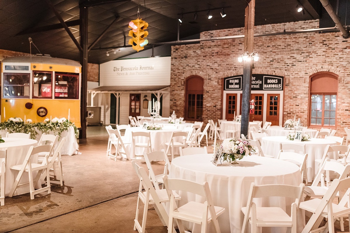 A photos of the tables and chairs set up for a wedding reception. 