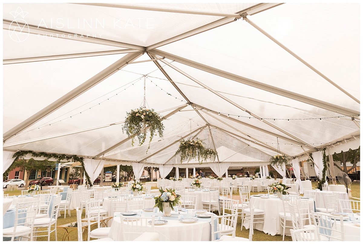 A tent with tables and chairs under it set-up on Museum Plaza for a wedding.