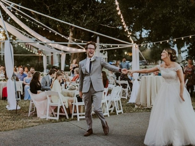 A bride and groom dancing at an outdoor wedding reception at the Barkley House