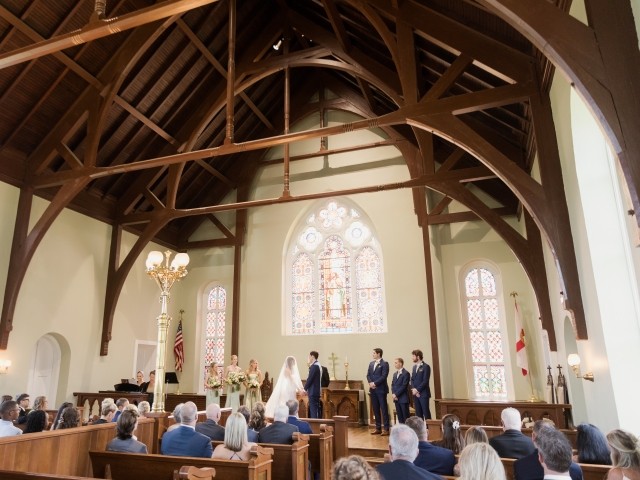 The interior of Old Christ Church in downtown Pensacola featuring wooden archways and stained glass windows