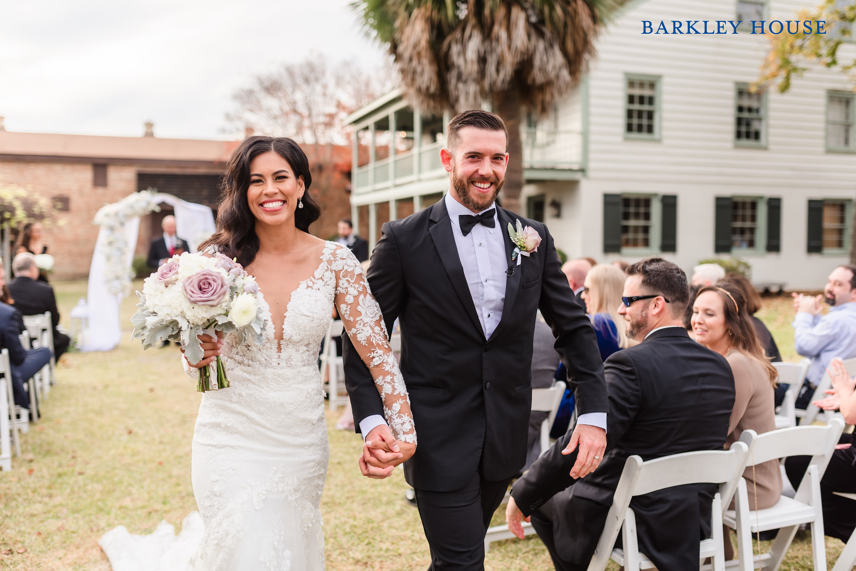 A Bride and Groom walk back down the aisle after their wedding ceremony at Barkley House gardens